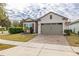 One-story home with two-car garage and landscaped front yard at 2156 Antilles Club Dr, Kissimmee, FL 34747