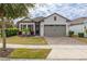 One-story home with two-car garage and landscaped yard at 2156 Antilles Club Dr, Kissimmee, FL 34747