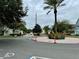 Community entrance with circular drive and landscaping at 2200 San Christabolo Dr # 106, Kissimmee, FL 34741