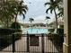 Refreshing community pool with palm trees and surrounding patio at 2200 San Christabolo Dr # 106, Kissimmee, FL 34741