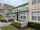 Two-story townhome with green siding, white picket fence, and landscaping at 2200 San Christabolo Dr # 106, Kissimmee, FL 34741