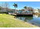 Relaxing community deck overlooking a serene lake with a swimming pool at 2200 San Christabolo Dr # 106, Kissimmee, FL 34741