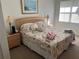 Main bedroom with a king-size bed, nightstands, and a window at 2200 San Christabolo Dr # 106, Kissimmee, FL 34741