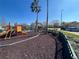 playground with colorful equipment and safety surface at 2200 San Christabolo Dr # 106, Kissimmee, FL 34741