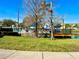 Relaxing pool area with blue umbrellas, lounge chairs, and a wooden deck at 2200 San Christabolo Dr # 106, Kissimmee, FL 34741