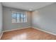 Light-filled bedroom featuring wood flooring and a window with blinds at 2223 Silver Pines Pl # 501, Orlando, FL 32808