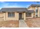 Front view of a tan house with gray roof and door at 2223 Silver Pines Pl # 501, Orlando, FL 32808