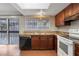 Kitchen with wood cabinets, white appliances, and tile floor at 2223 Silver Pines Pl # 501, Orlando, FL 32808