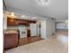 Kitchen with wood cabinets, white appliances, and tile floor at 2223 Silver Pines Pl # 501, Orlando, FL 32808
