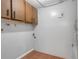 Small laundry room with upper cabinets and tile floor at 2223 Silver Pines Pl # 501, Orlando, FL 32808