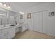 Double vanity bathroom with a large mirror and linen closet at 2612 Yountville Ave, Kissimmee, FL 34741