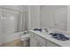 Clean bathroom with a tub, shower, and white vanity at 2612 Yountville Ave, Kissimmee, FL 34741
