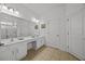 Double vanity bathroom with a large mirror and tile flooring at 2612 Yountville Ave, Kissimmee, FL 34741