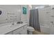 Bathroom with shower/tub combo, white vanity, and patterned shower curtain at 2612 Yountville Ave, Kissimmee, FL 34741