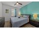 Bedroom with a queen bed, teal accent wall, and wood-look flooring at 2612 Yountville Ave, Kissimmee, FL 34741