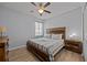 King-size bed in a spacious bedroom with wood-look floors at 2612 Yountville Ave, Kissimmee, FL 34741