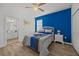 Bedroom with ensuite bathroom and blue accent wall at 2612 Yountville Ave, Kissimmee, FL 34741