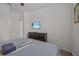 Bright bedroom with a queen bed and mounted TV. Includes dresser and closet at 2612 Yountville Ave, Kissimmee, FL 34741