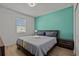 Bright bedroom with a king-size bed and teal accent wall at 2612 Yountville Ave, Kissimmee, FL 34741