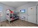 Bedroom with bunk beds, TV, and wood-look floors at 2612 Yountville Ave, Kissimmee, FL 34741