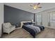 Bedroom with queen bed, accent chair, and dark gray accent wall at 2612 Yountville Ave, Kissimmee, FL 34741