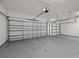 Two-car garage with white walls and concrete floor at 2612 Yountville Ave, Kissimmee, FL 34741