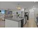 Open concept kitchen with granite island and stainless steel appliances at 2612 Yountville Ave, Kissimmee, FL 34741