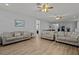 Open living area with multiple couches and wood-look floors at 2612 Yountville Ave, Kissimmee, FL 34741