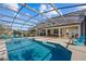 Inviting screened-in pool with lounge chairs and a covered patio at 2612 Yountville Ave, Kissimmee, FL 34741