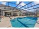 Inviting pool area with screened enclosure, lounge chairs, and a spacious deck at 2612 Yountville Ave, Kissimmee, FL 34741