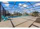 Relaxing pool with patio furniture under a screened enclosure at 2612 Yountville Ave, Kissimmee, FL 34741