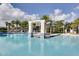 Expansive community pool with palm trees and shade structures at 2612 Yountville Ave, Kissimmee, FL 34741