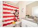 Bathroom with Mickey Mouse shower curtain and gray vanity at 2746 Bookmark Dr, Kissimmee, FL 34746