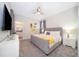 Main bedroom with gray upholstered bed and en-suite bathroom at 2746 Bookmark Dr, Kissimmee, FL 34746