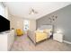 Spacious bedroom with gray walls and a yellow patterned comforter at 2746 Bookmark Dr, Kissimmee, FL 34746