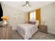 Bright bedroom with mustard yellow curtains and wood nightstands at 2746 Bookmark Dr, Kissimmee, FL 34746