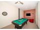Fun game room with a pool table, dartboard, and brick feature wall at 2746 Bookmark Dr, Kissimmee, FL 34746