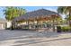 Covered seating area with tables and chairs near the pool at 2746 Bookmark Dr, Kissimmee, FL 34746