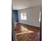 Bright bedroom with wood-look floors and blue accent wall at 34429 Laralack Ave, Leesburg, FL 34788