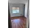Bedroom with wood-look floors and window at 34429 Laralack Ave, Leesburg, FL 34788