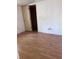 Simple bedroom with wood-look floors and closet at 34429 Laralack Ave, Leesburg, FL 34788