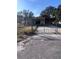 Tan single-story home with carport and chain link fence at 34429 Laralack Ave, Leesburg, FL 34788