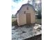 Tan shed with a brown door and a concrete slab at 34429 Laralack Ave, Leesburg, FL 34788