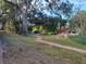 Landscaped backyard with a brick pathway, lush greenery, and a gazebo at 4332 S Kirkman Rd # 1013, Orlando, FL 32811