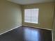 Bright bedroom featuring dark laminate floors and window blinds at 4332 S Kirkman Rd # 1013, Orlando, FL 32811