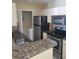 Kitchen with granite countertops and stainless steel appliances at 4332 S Kirkman Rd # 1013, Orlando, FL 32811