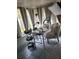 Bright living room with tiled flooring, natural light, salon-style table, and decorative hanging plants at 4749 Hopespring Dr, Orlando, FL 32829