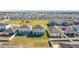Aerial view of houses in a residential neighborhood with a park nearby at 583 Taft Dr, Davenport, FL 33837