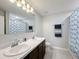 Bathroom with double sinks, large mirror, and shower/tub combo at 583 Taft Dr, Davenport, FL 33837