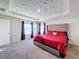 Main bedroom with red bedding and two windows at 583 Taft Dr, Davenport, FL 33837